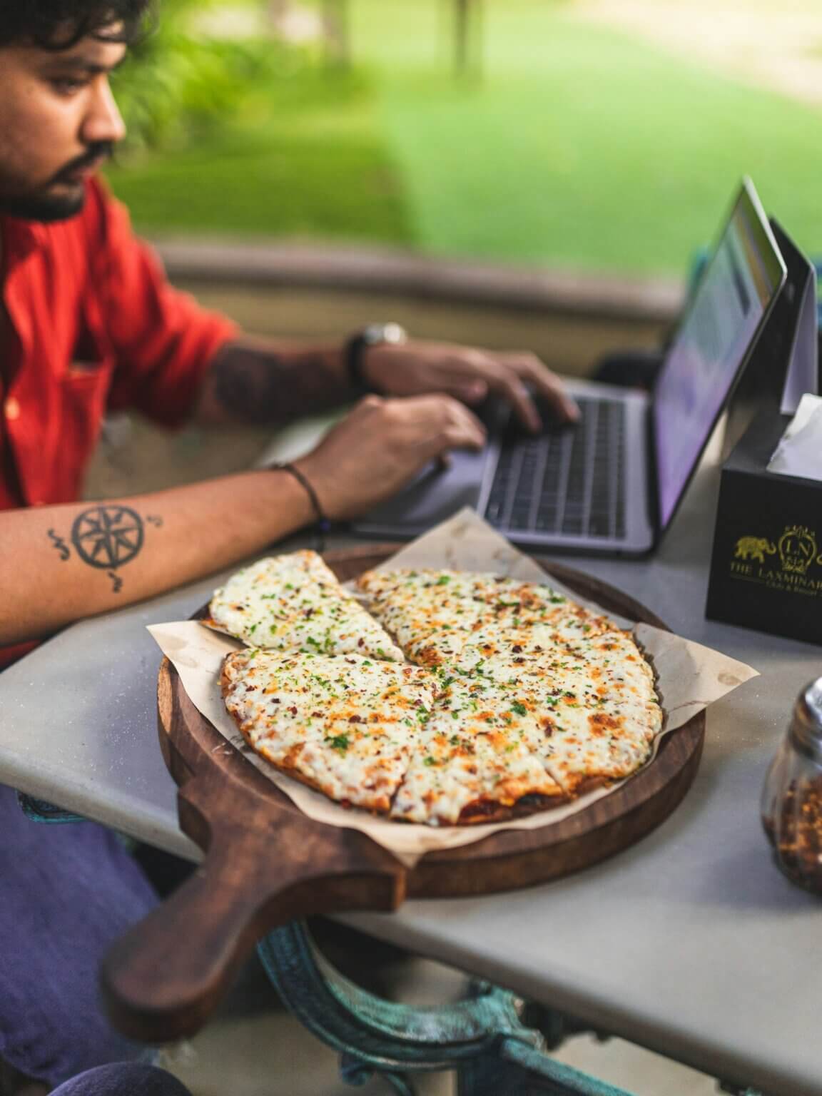 pizza next to laptop